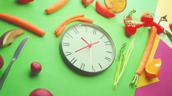Image of a clock surrounded by healthy food