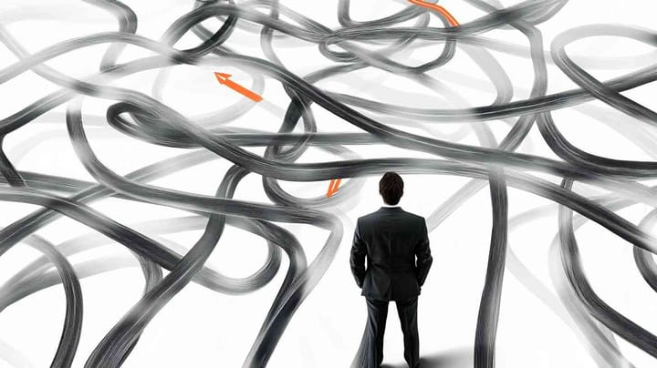 Image of a man in a suit looking at a complex arrangement of strings