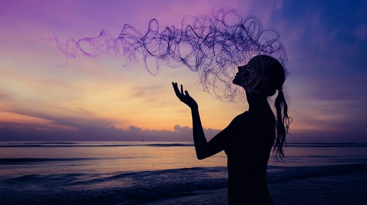 Image of spirals coming out of a head with a purple sunset behind